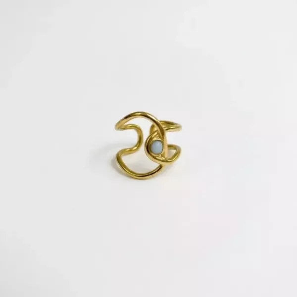 Bague vague ajourée et pierre blanche dorée