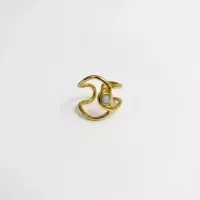 Bague vague ajourée et pierre blanche dorée